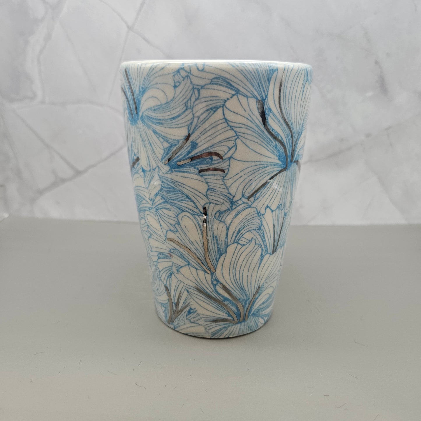 Light blue hibiscus print mug with 22k white gold handle and accents, 14 oz