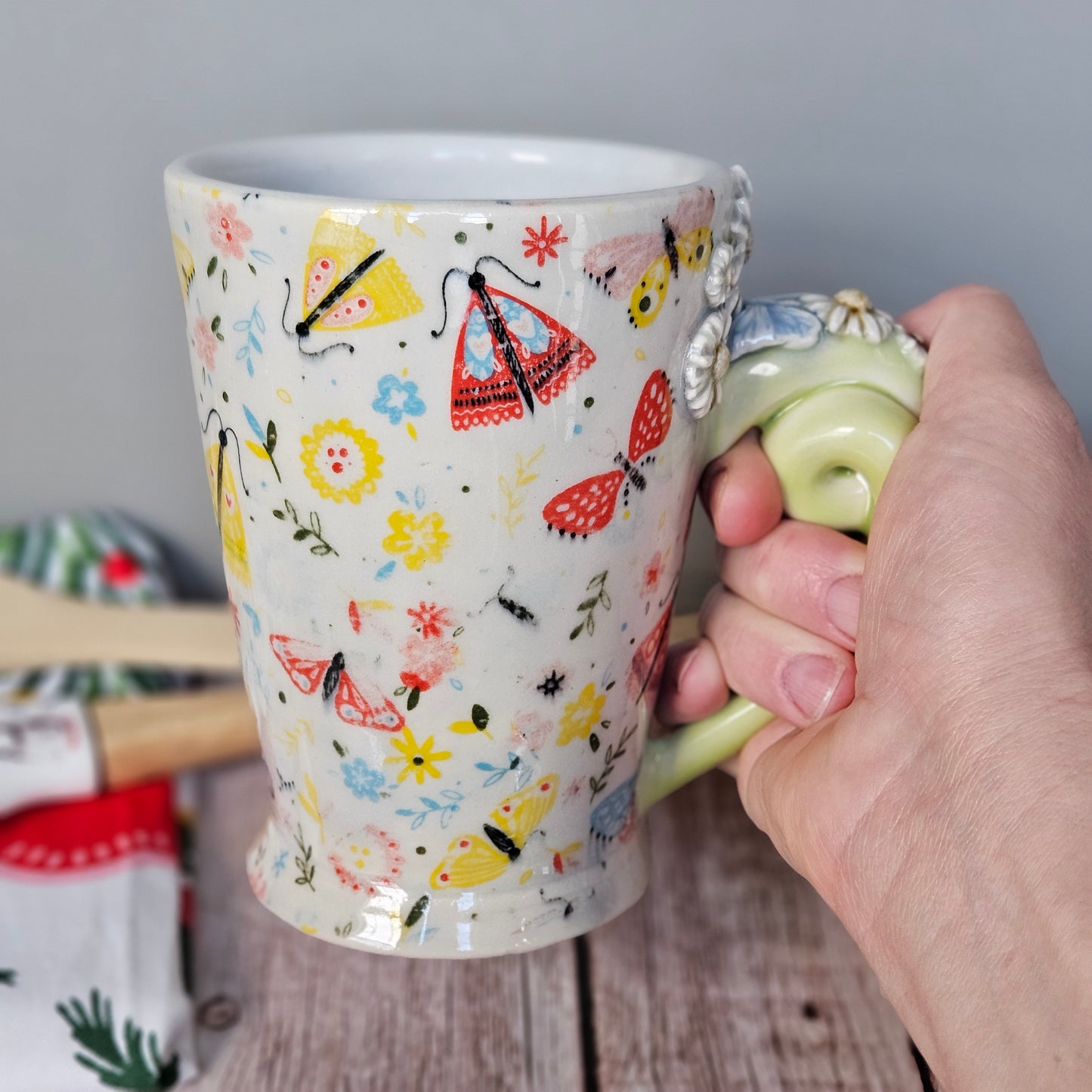 Yellow-Green and white floral and butterfly mug with pigtail handle