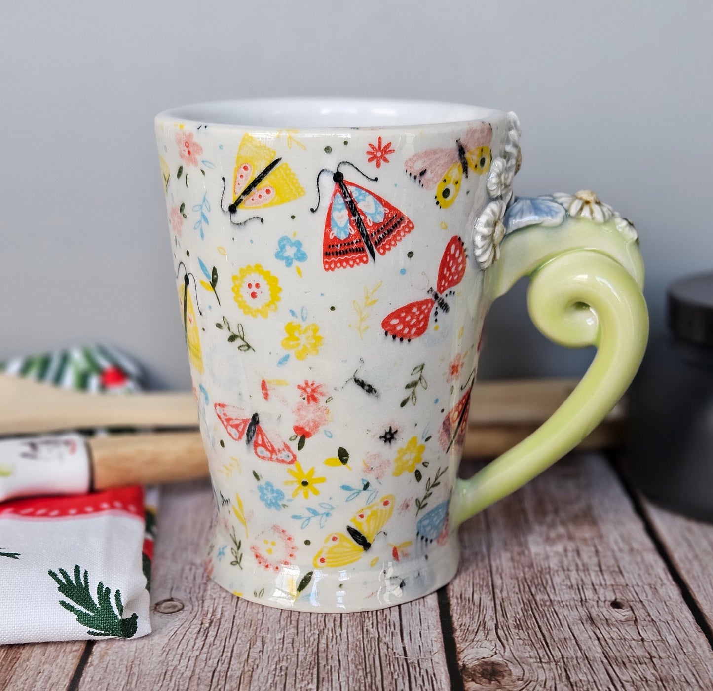 Yellow-Green and white floral and butterfly mug with pigtail handle