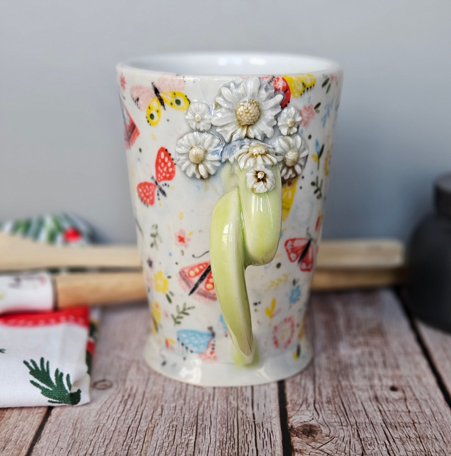 Yellow-Green and white floral and butterfly mug with pigtail handle