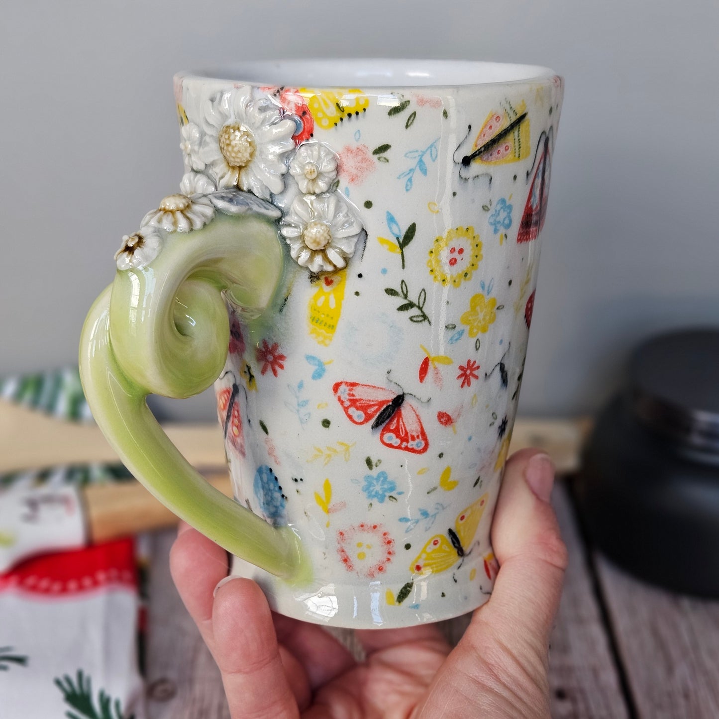 Yellow-Green and white floral and butterfly mug with pigtail handle