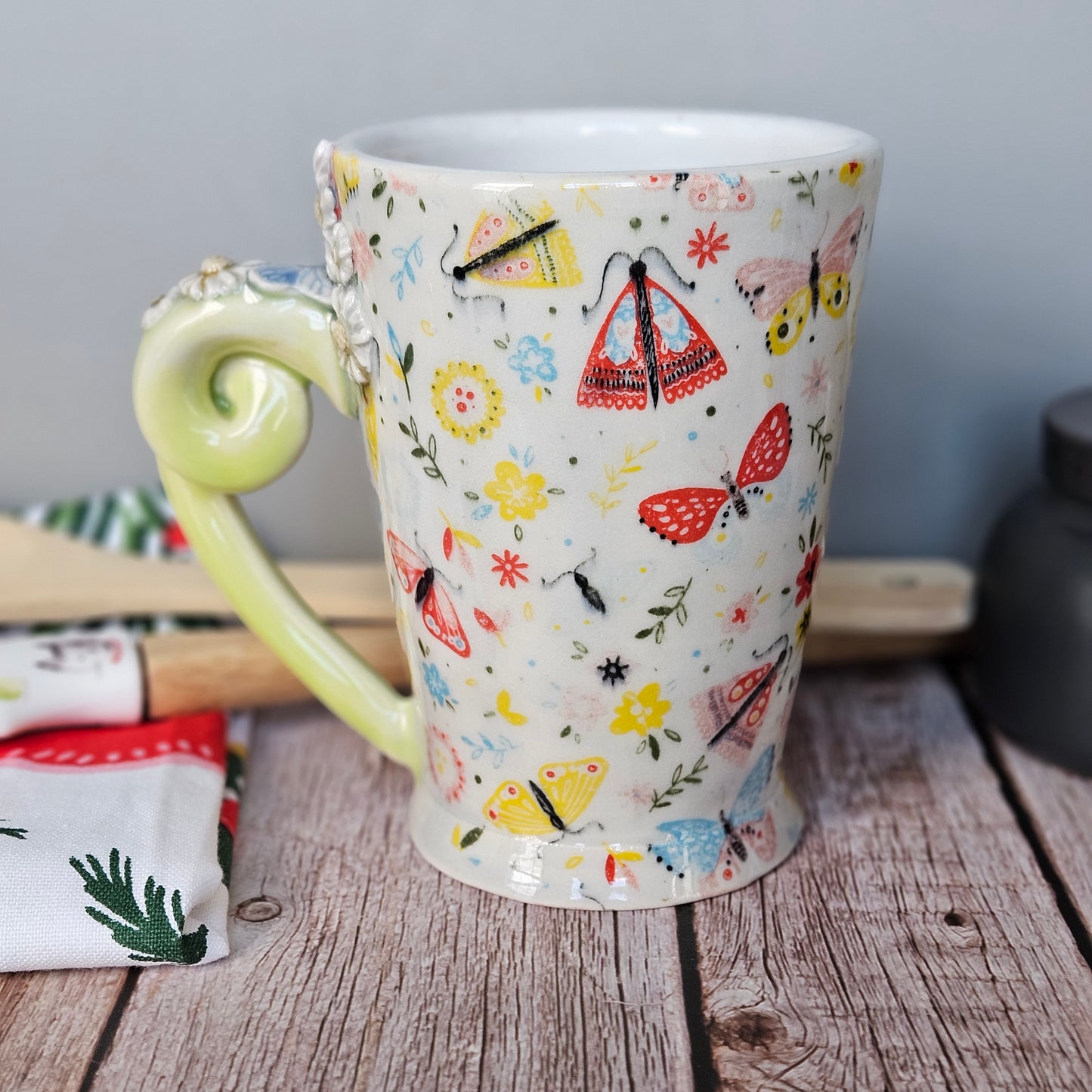 Yellow-Green and white floral and butterfly mug with pigtail handle