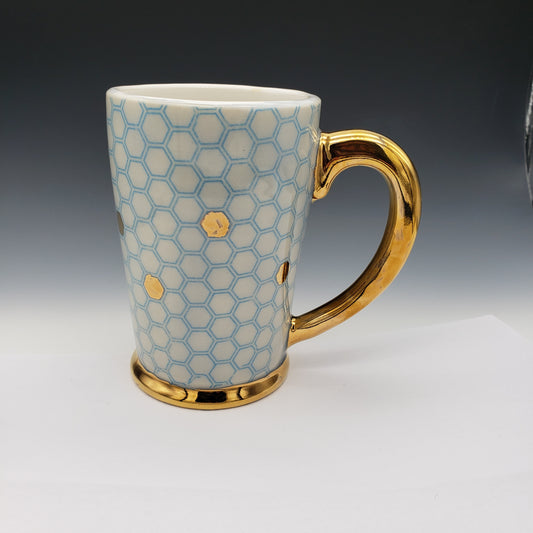 Blue and white honeycomb mug with 14k yellow gold on the handle and base.